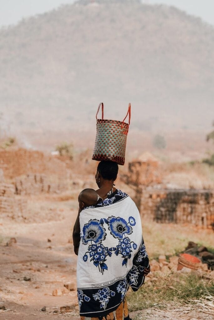 woman in white and blue floral shirt wearing red and white floral bucket hat